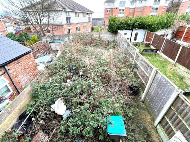 This is the view from the second bedroom of the back garden. It's overgrown and unkempt now, but it's also a sizeable space that could be part-utilised for an extension, subject to planning permission.