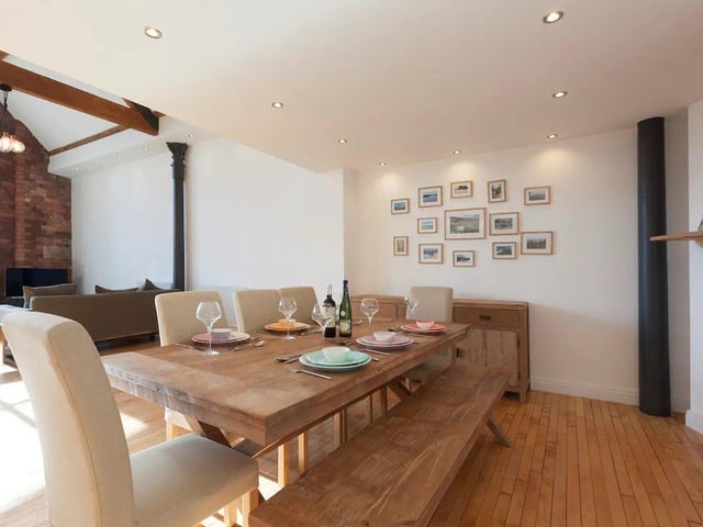 Shops, bars and restaurants are at the Airbnb's doorstep, with a huge dining table indoors for those who prefer to stay in and enjoy the loft of an evening.