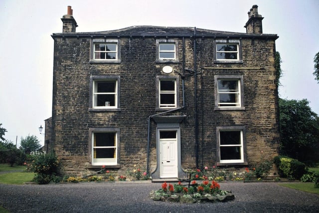 Boyle hall located of Haigh Moor Road in July 1971. This part of the building dates from 1799 and was built by John and Hannah Boyle. Boyle Hall is constructed in hammerdressed stone with a stone slate roof. It has three storeys and a three bay symmetrical facade with a central entrance.