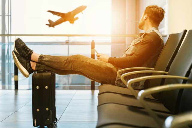 Passenger waits in the departure lounge of an airport