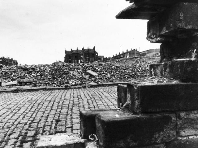 This house standing in the middle of a slum clearance area in Hyde Park was the home of Emilia McCourt. She was the only resident left in Howden Place by May 1976.