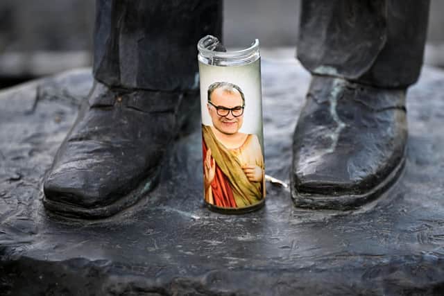 TOPSHOT - A candle with an image of previous manager Marcelo Bielsa is seen on the base of a statue of legendary former manager Don Revie ahead of the English Premier League football match between Leeds United and Chelsea at Elland Road in Leeds, northern England on May 11, 2022. (Photo by Oli SCARFF / AFP) (Photo by OLI SCARFF/AFP via Getty Images)
