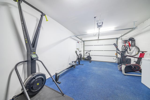 Sitting off the kitchen is a good-sized utility room having a range of units and access through to a large integral garage which is currently enjoyed as a gym.