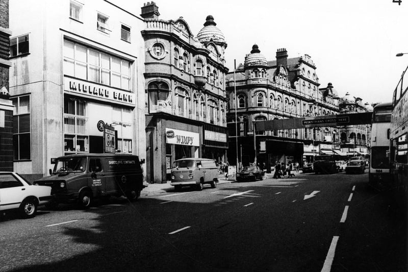 Vicar Lane looking north towards the junction with Eastgate pictured in Februiary 1982. At the left edge the narrow entrance between buildings is Fish Street. The Midland Bank is in view as well as Wimpy and Famous Army Stores Ltd.