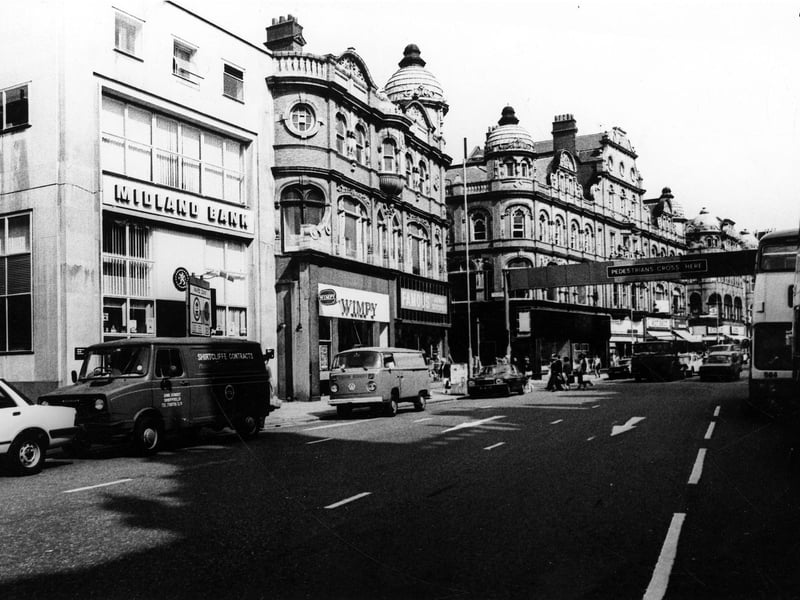 Vicar Lane looking north towards the junction with Eastgate pictured in Februiary 1982. At the left edge the narrow entrance between buildings is Fish Street. The Midland Bank is in view as well as Wimpy and Famous Army Stores Ltd.
