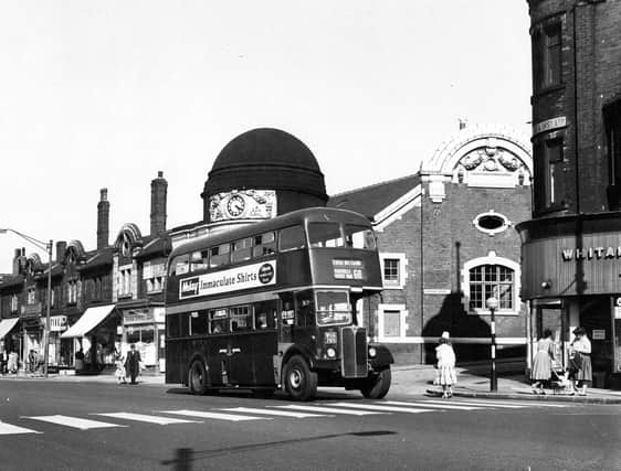 The junction of Roundhay Road, on the left and Karnac Road on the right in August 1962. In the centre of the image number 68 Harehills/Easterly Road bus approaches a zebra crossing on its way back to the Central Bus Station. On the side of the bus an advertisement promotes 'Mckay, Immaculate Shirts, Calpreta wonder dry finish'. The parade of shops behind the bus was demolished in 1968 however the building with the clock dome number 250 is The Picture House. This 900 seat cinema opened on Monday, December 16,  1912 showing 'The Mine Owner' and closed Saturday, October 5, 1963, showing 'Last Days of Pompeii'. On Friday, October 11, 1963, it went into use as a bingo hall.