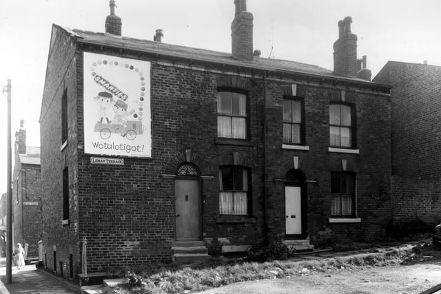 A woman can be seen passing the end of Maden Street. Elland Road is on the left. Two houses on Leman Terrace are in view.