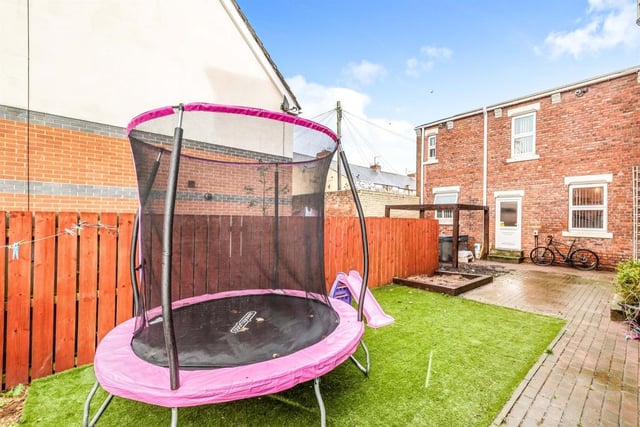 The rear garden offers a patio and a children's sand pit area.