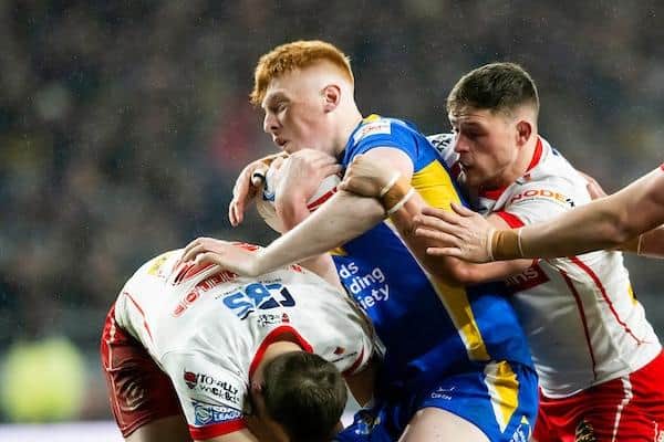 Leeds Rhinos' Luis Roberts is tackled by Joe Batchelor and Morgan Knowles, of St Helens. Picture by Allan McKenzie/SWpix.com.