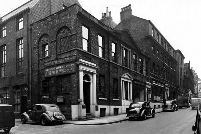 The junction of Albion Street and Butts Court (on the left) in August 1949. The premises are (Albion Street); number 77, G.L. Barker, accountant; number 79, J.W. Bulmer, tailor; number 81, Hindle, Son & Lewis, estate agents. On Butts Court are the premises of Wiggins, Teape & Alex Pirie Ltd, paper makers, and Allied Paper Merchants Ltd. (Joseph Towne & Sons).