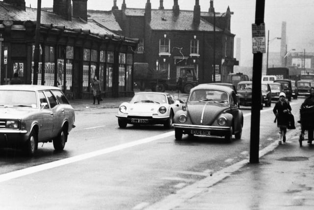 A VW Beetle makes its  way down Kirkstall Road in March 1975.