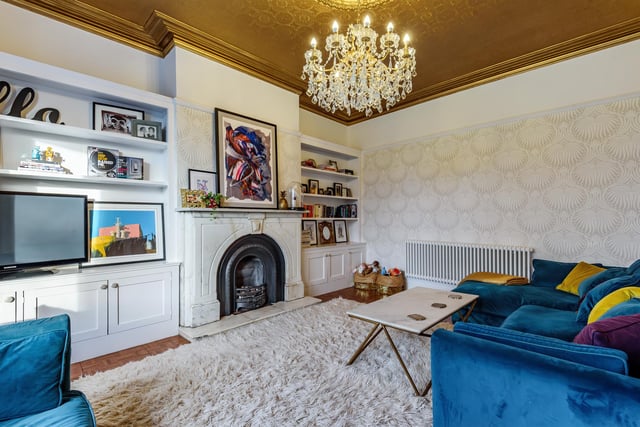 The spacious lounge boasts a marble fireplace with storage and shelving built into the chimney breast recesses, as well as a bay window which fills the room with natural light.