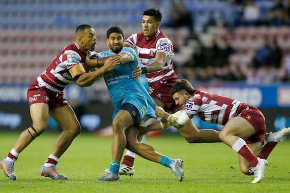 Willie Isa, left, pictured tackling Rhinos' Nene Macdonald with teammates Kai Pearce-Paul and Cade Cust, has been ruled out of Wigan's side through injury. Picture by Ed Sykes/SWpix.com
