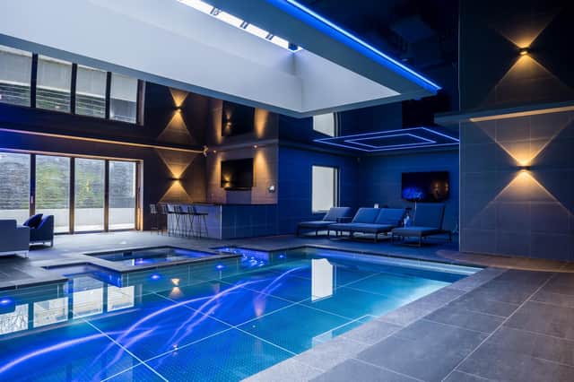 The stainless steel, 15m swimming pool with spa pool is part of a suite with sauna, gym or dance studio, a bespoke bar, and changing rooms with showers and toilets.