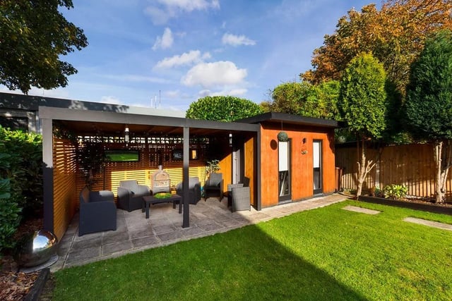 The property boasts a large and well-presented rear garden with a sheltered patio space and modern garden storage room
