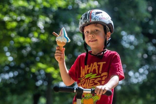 Pictured is Oliver Howson, aged 5, of Leeds, enjoying an ice-cream after playing on his scooter.