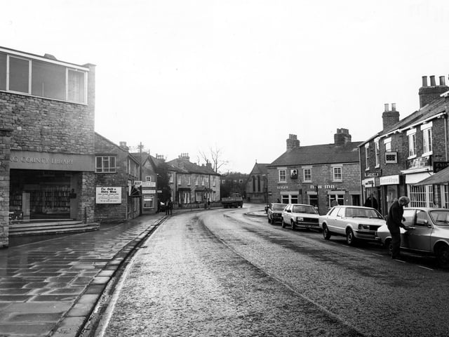 Westgate with Wetherby public library on the left, followed by the Gold & Watch shop, jewellers, Renfree & Helliwell, estate agents, and the Blue Bird Cafe. Across the road is the New Inn public house, and shops including Double A travel agents, Bradford & Bingley building society and Joan Sutcliffe Gifts. Pictured in May 1997.