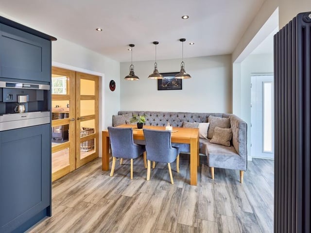 The dining area features low-level lighting to create a different atmosphere and offers the ideal space to host around the table with corner banquette seating.