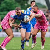 Leeds Rhinos captain Cameron Smith is tackled by Dean Hadley and Elliot Minchella during the loss to Hull KR. Picture by Alex Whitehead/SWpix.com.