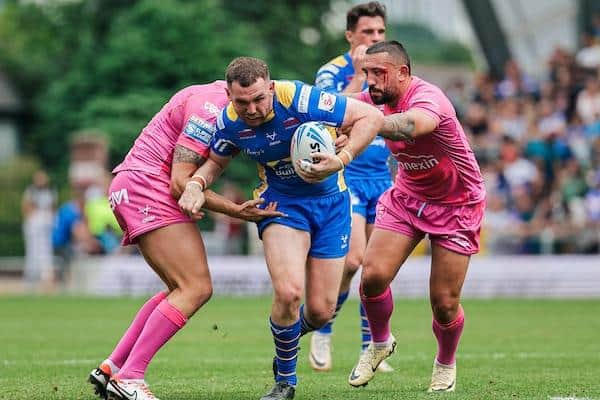Leeds Rhinos captain Cameron Smith is tackled by Dean Hadley and Elliot Minchella during the loss to Hull KR. Picture by Alex Whitehead/SWpix.com.