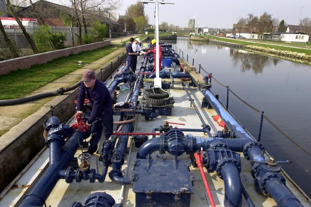 Bargemen deliver fuel to the Total Butler site by the Aire Calder Navigation on Lock Lane, Castleford, on April 3, 2002.