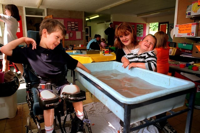 Children enjoy themselves on the 'family fun scheme' at John Jamieson School in Oakwood in July 1997. Pictured, from left, are Nathan Pride and Sharon Bottomley with her son Jordan.