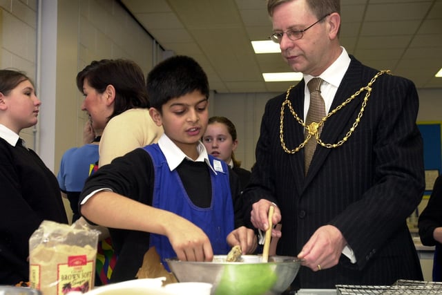 Deputy lord mayor of Leeds, Coun Mike Fox, helps pupil Umar Ismail with his baking during his visit to mark the completion of phase one of the new Roundhay School Technology College on November 2, 2002.