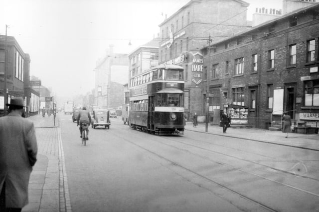 Tram no. 538 travelling along Wellington Street on route no. 18 to Cross Gates. James Hare Ltd., woollen merchants and manufacturers can be seen at 72 Wellington Street. National bus station is visible on the right. Pictured in September 1954.