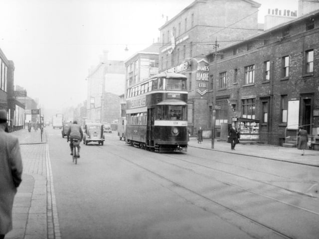Tram no. 538 travelling along Wellington Street on route no. 18 to Cross Gates. James Hare Ltd., woollen merchants and manufacturers can be seen at 72 Wellington Street. National bus station is visible on the right. Pictured in September 1954.