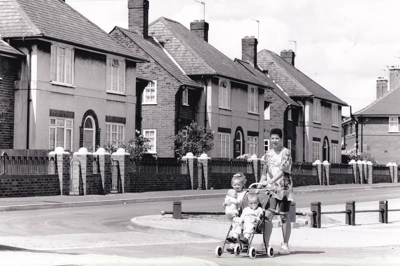 A mum and her two young children make their way down Coldcotes Crescent in July 1992.