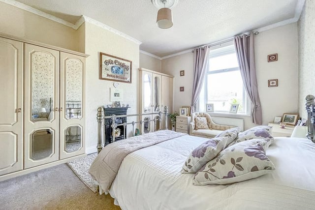 This lovely double bedroom with period fireplace has fitted wardrobes.