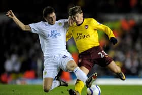 LEEDS, ENGLAND - JANUARY 19: Alex Bruce of Leeds United challenges Andrey Arshavin of Arsenal during the FA Cup sponsored by E.On Third Round Replay match between Leeds United and Arsenal at Elland Road on January 19, 2011 in Leeds, England. (Photo by Michael Regan/Getty Images)