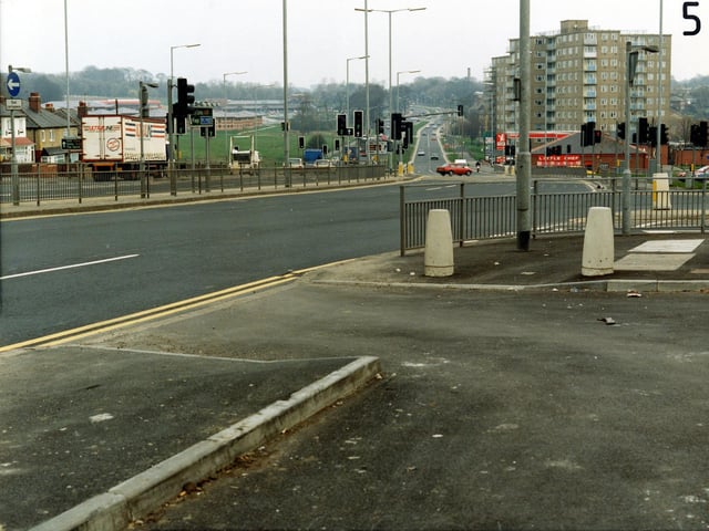Looking east along York Road in March 1991, taken from the lay-by outside the shops. The junction with Rookwood Avenue is on the right, followed by the Little Chef restaurant and petrol filling station, and behind these blocks of high-rise flats.