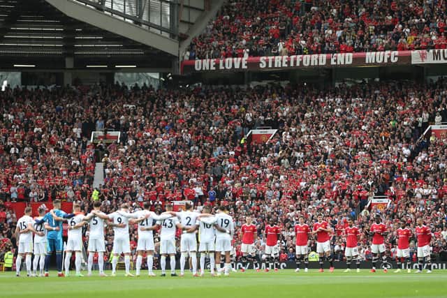 MANCHESTER, ENGLAND - AUGUST 14: Players stand for a minutes applause for the players and staff who have lost their lives over the last year prior to the Premier League match between Manchester United  and  Leeds United at Old Trafford on August 14, 2021 in Manchester, England. (Photo by Alex Morton/Getty Images)