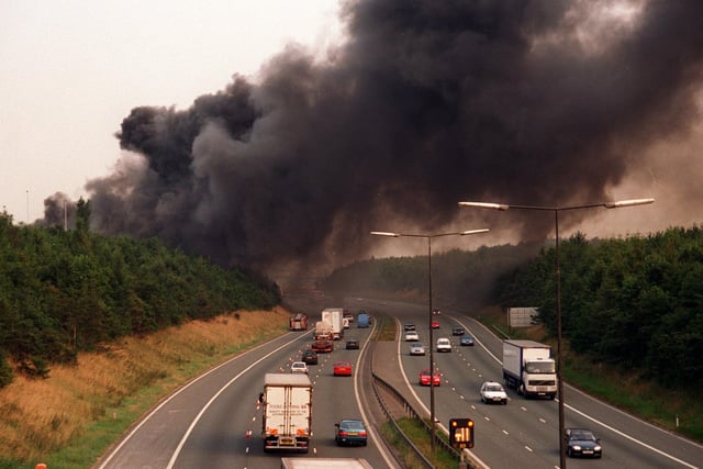 Thick smoke blows across the M62 motorway from a fire at Britannia Bathrooms in Morley in August 1997.