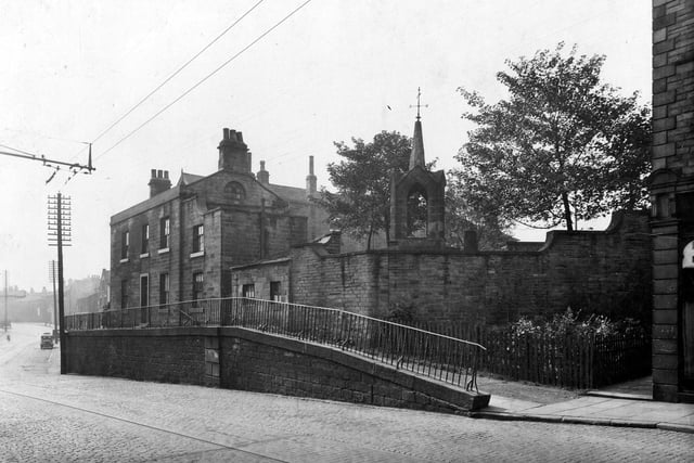 Stocks Hill, looking towards Bramley Town End. Stocks Hill is rising from the main road, topped with railings. The monument over the stone wall is the remains of the tower of St. Margaret's Church. Pictured in  September 1933.