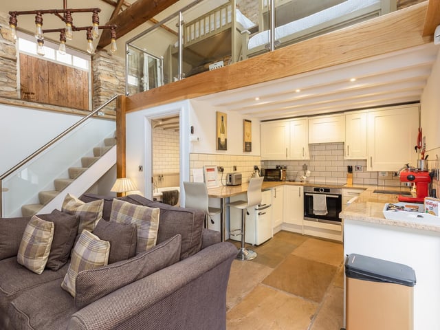 A self-contained studio with mezzanine was created within a nineteenth century cow shed, and
could be used for guests, independent family members, or as a holiday let.