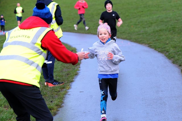 A smile from a young runner as she finishes the race