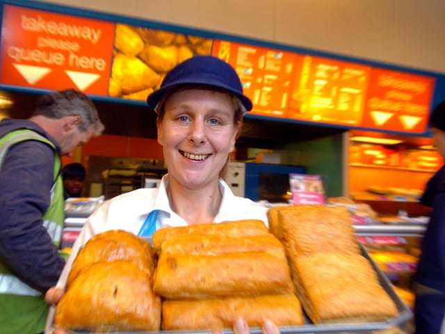 Shop Support manager Sue Abbott at Greggs on The Headrow holds a tray of Cornish pasties, sausage rolls and chicken pasties.
