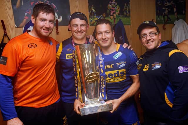 Jason Davidson, right, with fellow backroom staff David O'Sullivan and RIchard Hunwicks and captain Danny McGuire in Rhinos' changing room at Old Trafford after the 2011 Grand Final. Picture by Vaughn Ridley/Swpix.