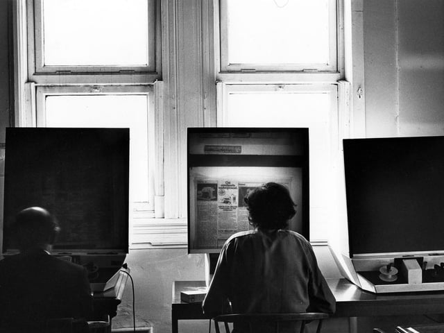 Members of the public use the microfilm reading machines at Leeds Central Library in April 1984. Many of the local newspapers were put onto microfilm in the late 1960s to reduce the amount of storage space needed. Currently available on microfilm are records of Births, Marriages and Deaths, along with Census entries and a wide selection of local, plus some national newspapers.