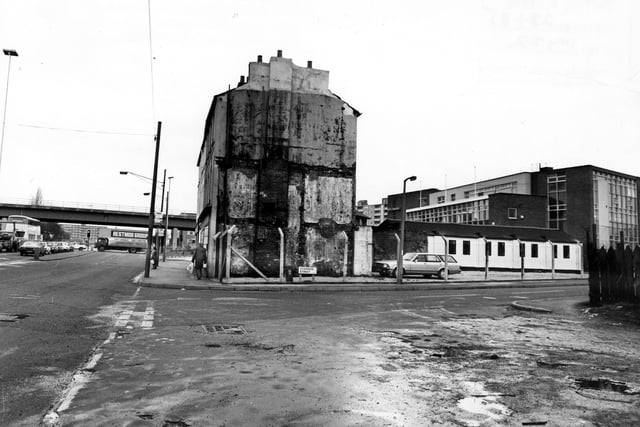 The junction of Shannon Street and Marsh Lane, showing the derelict looking gable end of no. 86 Marsh Lane in the centre. Moving right onto Shannon Street, the single-storey white building is a petrol station while the taller building behind is Adleman's Clothiers and Outfitters. On the left, the junction with York Road can be seen with the road bridge running overhead. Pictured in January 1985.