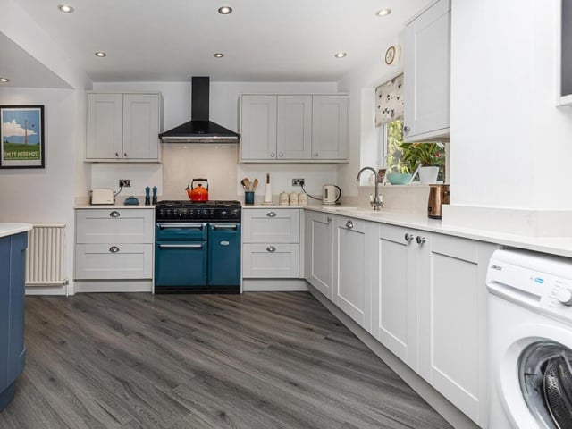The kitchen with breakfast room has bespoke fitted units.
