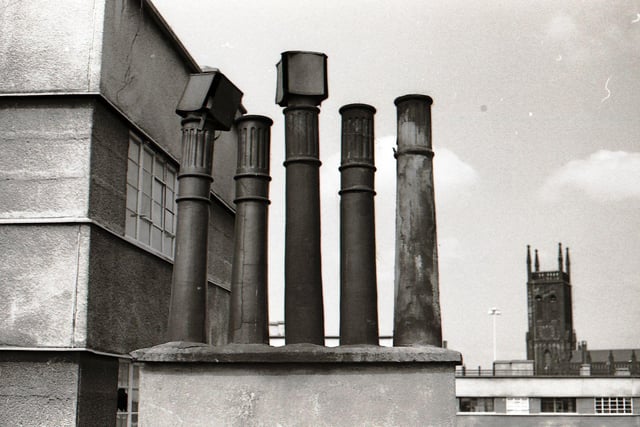 Rooftops and chimneys of Quarry Hill Flats, looking across to St. Mary's Church, Mabgate in the background, taken during the time the flats were in the process of demolition.