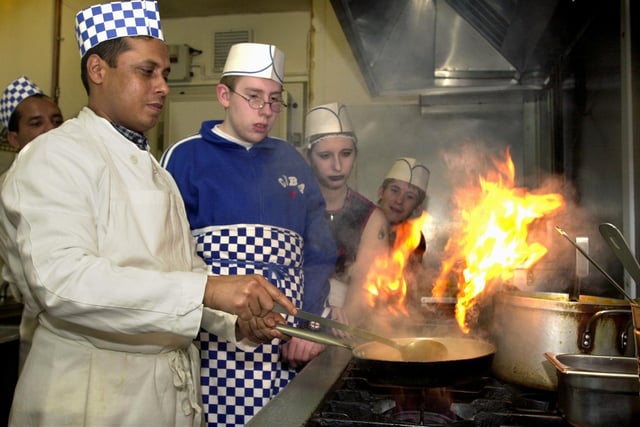 Chef Anwar Miah at the Ruchee restaurant demonstrates the art of cooking to students from Elmete Wood special school in Roundhay, from left, James Sanderson, Kimberley Knowles and Simon Tunstall, on December 5, 2002.