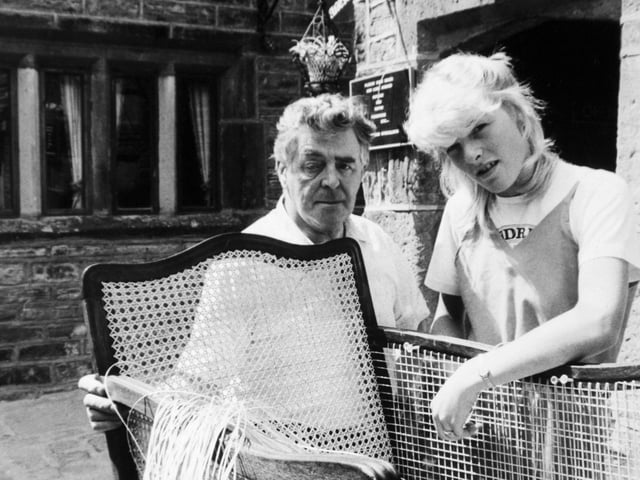 Harry Fowler and his granddaughter, Tracey work on a bergere cane chair at Booth's Yard Antiques in Lowtown in March 1984.