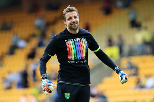 NORWICH, ENGLAND - MAY 22: Tim Krul of Norwich City warms up wearing a shirt in support of Blackpool footballer, Jake Daniels prior to the Premier League match between Norwich City and Tottenham Hotspur at Carrow Road on May 22, 2022 in Norwich, England. (Photo by David Rogers/Getty Images)