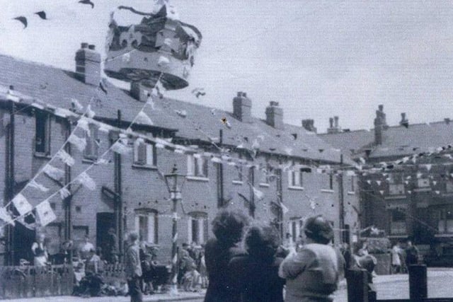 Bunting across the street, and a giant crown, above Copperfield Avenue, off Cross Green Lane, during celebrations for the coronation. Houses on Copperfield View can be seen on the right.