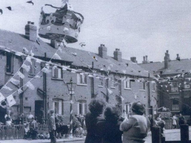 Bunting across the street, and a giant crown, above Copperfield Avenue, off Cross Green Lane, during celebrations for the coronation. Houses on Copperfield View can be seen on the right.