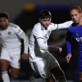 WIMBLEDON, ENGLAND - FEBRUARY 01: Ed Leach of AFC Wimbledon goes past Jay Buchan of Leeds Utd during the FA Youth Cup fourth round match between AFC Wimbledon and Leeds United at The Cherry Red Records Stadium on February 01, 2023 in Wimbledon, England. (Photo by Julian Finney/Getty Images)